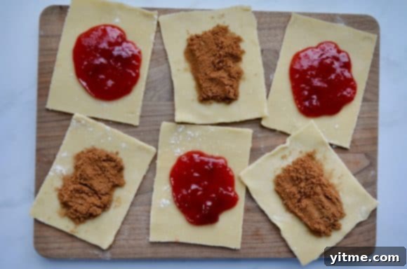 Homemade Pop Tarts: Double the Deliciousness 4 Wood cutting board with alternating strawberry and cinnamon filled pop tarts