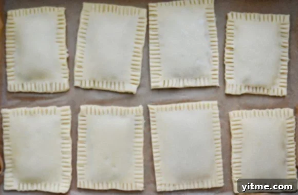 Homemade Pop Tarts: Double the Deliciousness 5 Easy homemade pop tarts on parchment paper lined baking sheet