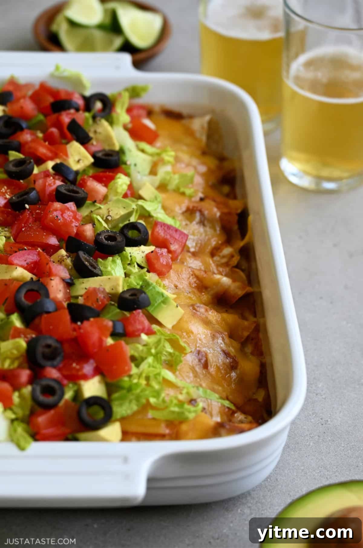 Weeknight Rotisserie Chicken Enchiladas 9 Easy chicken enchiladas made with rotisserie chicken and homemade enchilada sauce topped with shredded lettuce, diced avocado and tomatoes, and black olives.