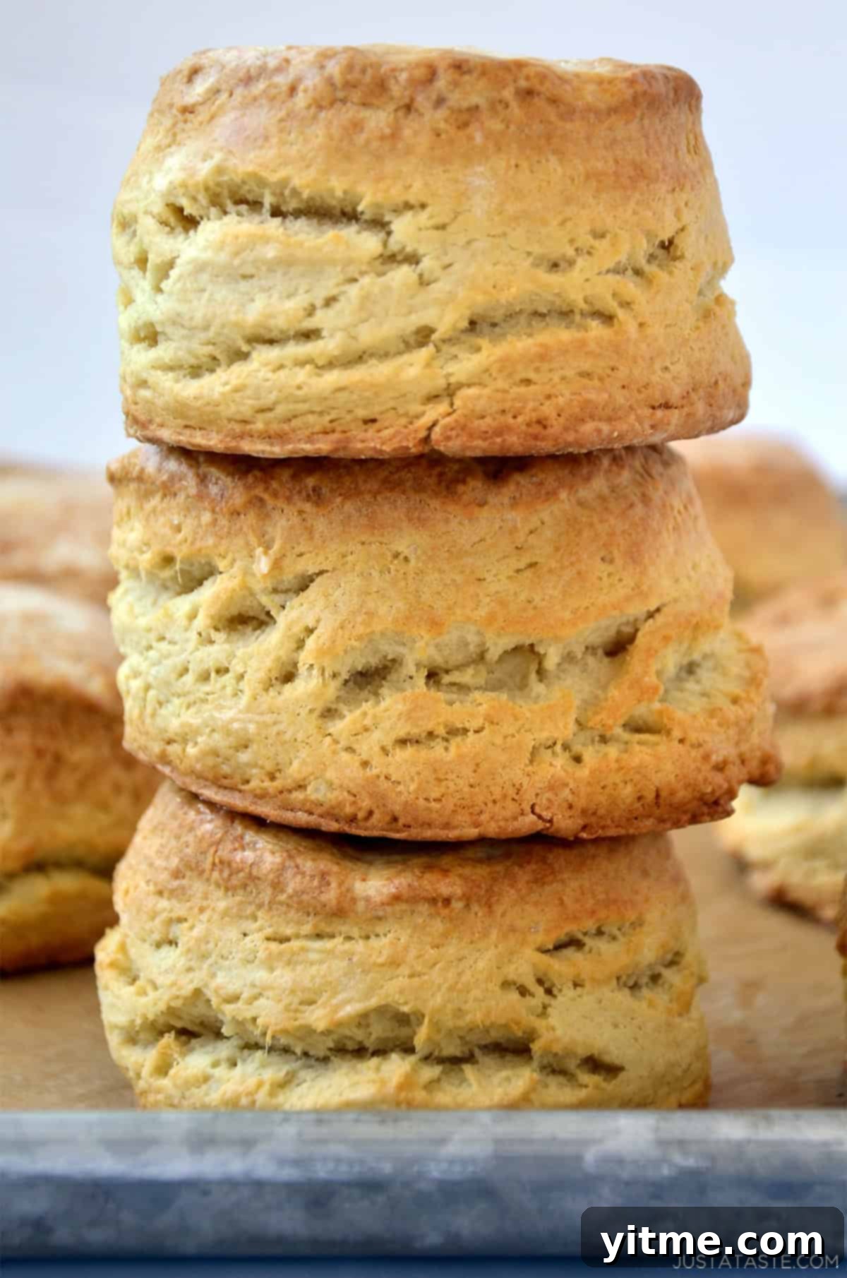 A stack of three homemade flaky buttermilk biscuits.