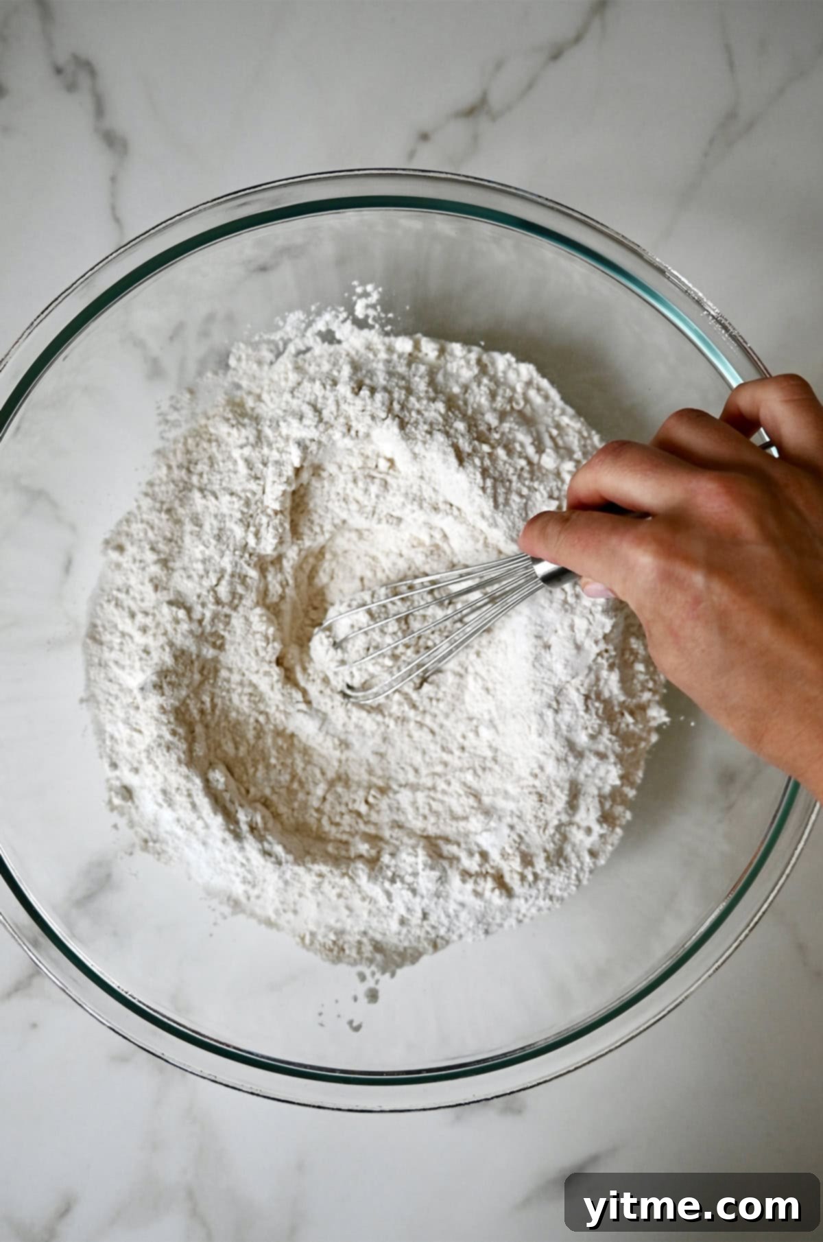 Whisking flour, baking powder, sugar and salt in a large bowl.
