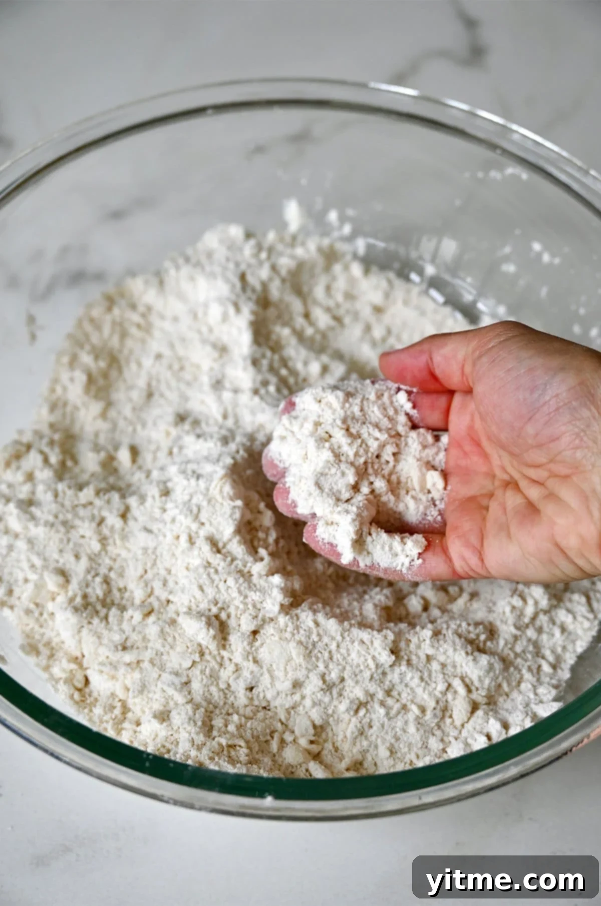 Grated butter worked into a flour mixture.