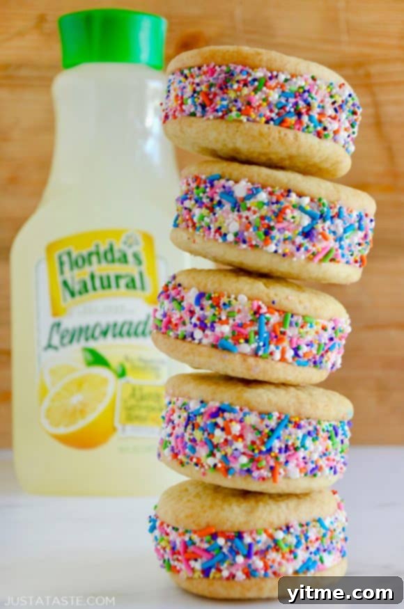 Quick Lemon Ice Cream Sandwiches 2 A stack of lemon ice cream sandwiches coated in sprinkles with a bottle of lemonade behind them