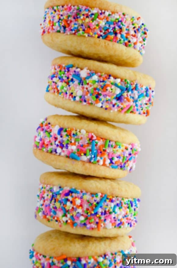 Quick Lemon Ice Cream Sandwiches 3 A close-up shot of a stack of ice cream cookie sandwiches rolled in rainbow sprinkles