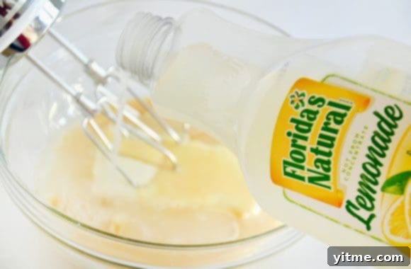 Quick Lemon Ice Cream Sandwiches 4 A bottle of lemonade being poured into a clear bowl containing cream cheese