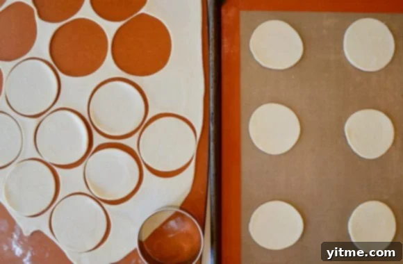 Effortless Blueberry Mini Pies 5 Pie dough rolled out and cut into small circles on a baking sheet