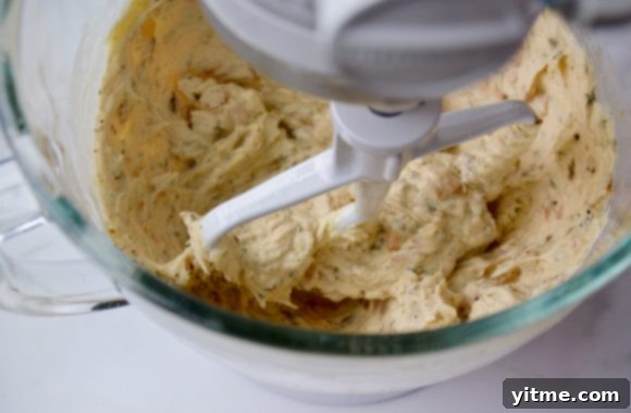 Golden Tomato and Sweet Onion Cheese Tart 5 Stand mixer bowl containing cheese mixture