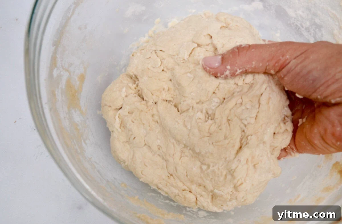 Smooth tortilla dough in a glass bowl.