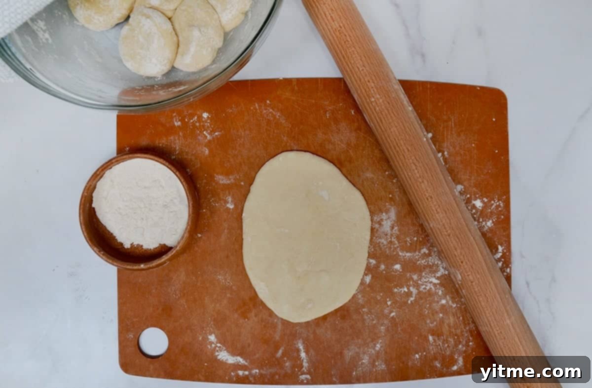 Rolling out flour tortillas with a rolling pin on a lightly floured surface.