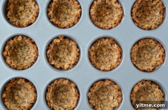 Top down view of freshly baked muffin tin filled with granola cups