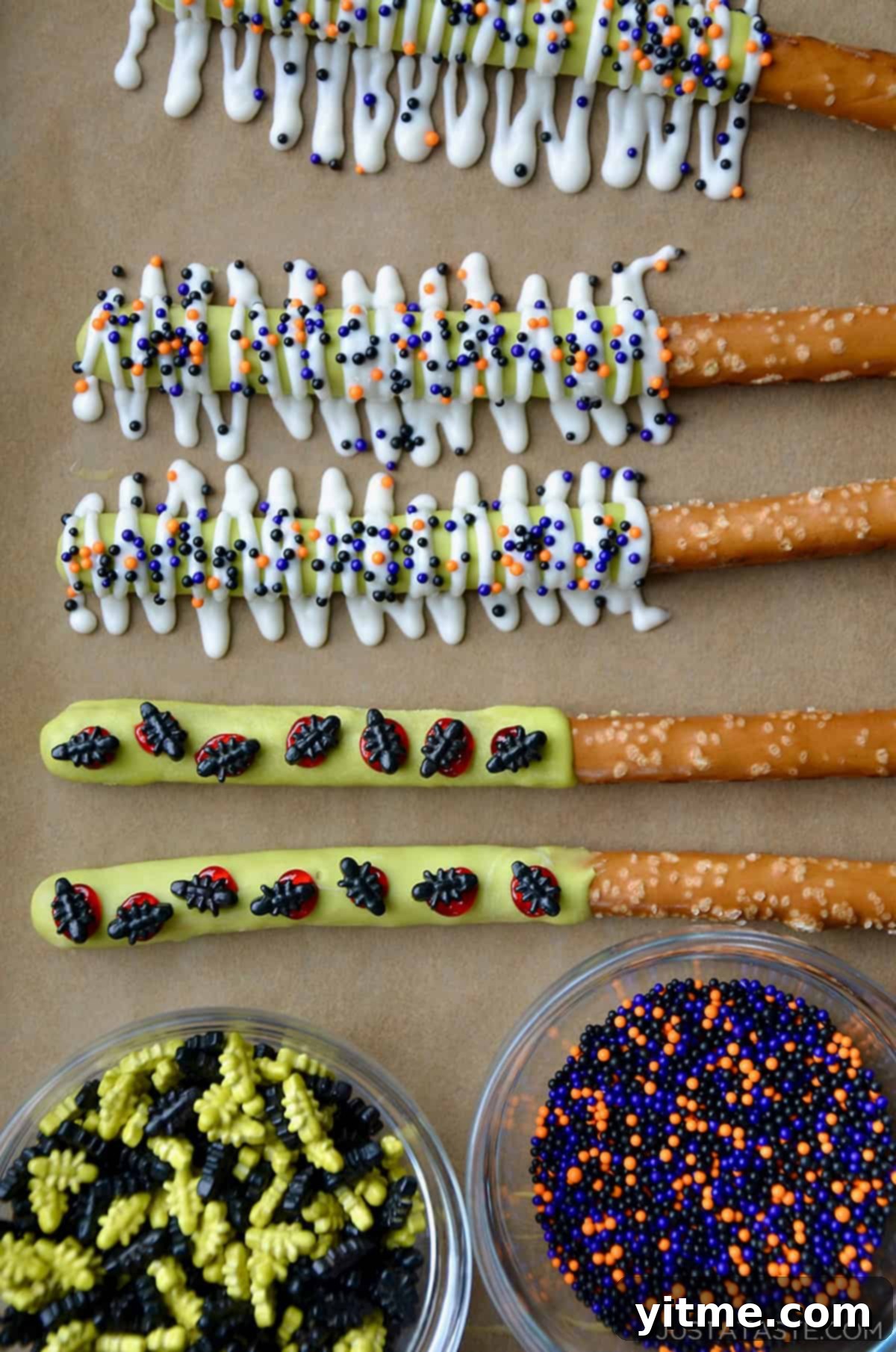 Spooky Halloween pretzels dipped in candy melts and topped with candy bugs and Halloween sprinkles.