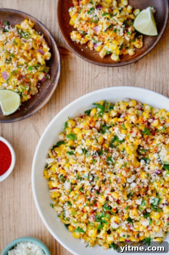 The best Elote Corn Salad topped with fresh herbs and Cotija cheese, vibrant and inviting