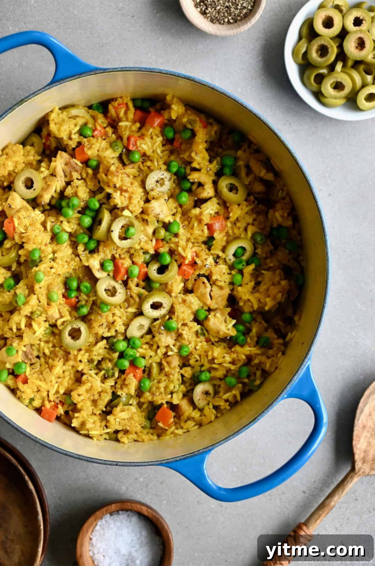 Chicken yellow rice and veggies in a Dutch oven.