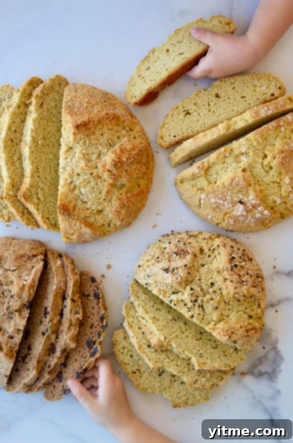 Four loaves of sliced bread with little kids hands grabbing slices