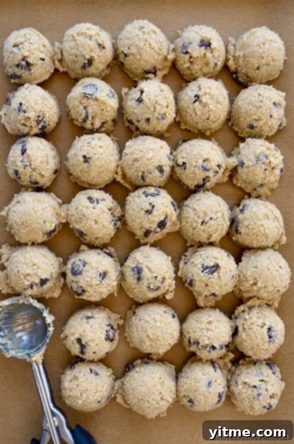 Scoops of edible cookie dough on parchment paper