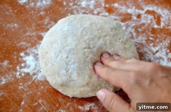 Effortless Cinnamon Swirls: A No-Yeast Recipe 4 A ball of cinnamon roll dough on a wood cutting board