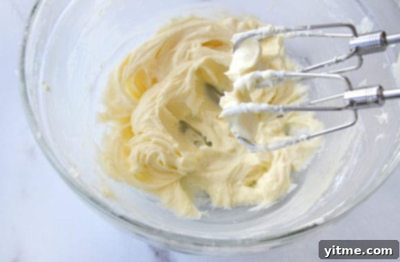 Effortless Cinnamon Swirls: A No-Yeast Recipe 8 A glass bowl with cream cheese frosting