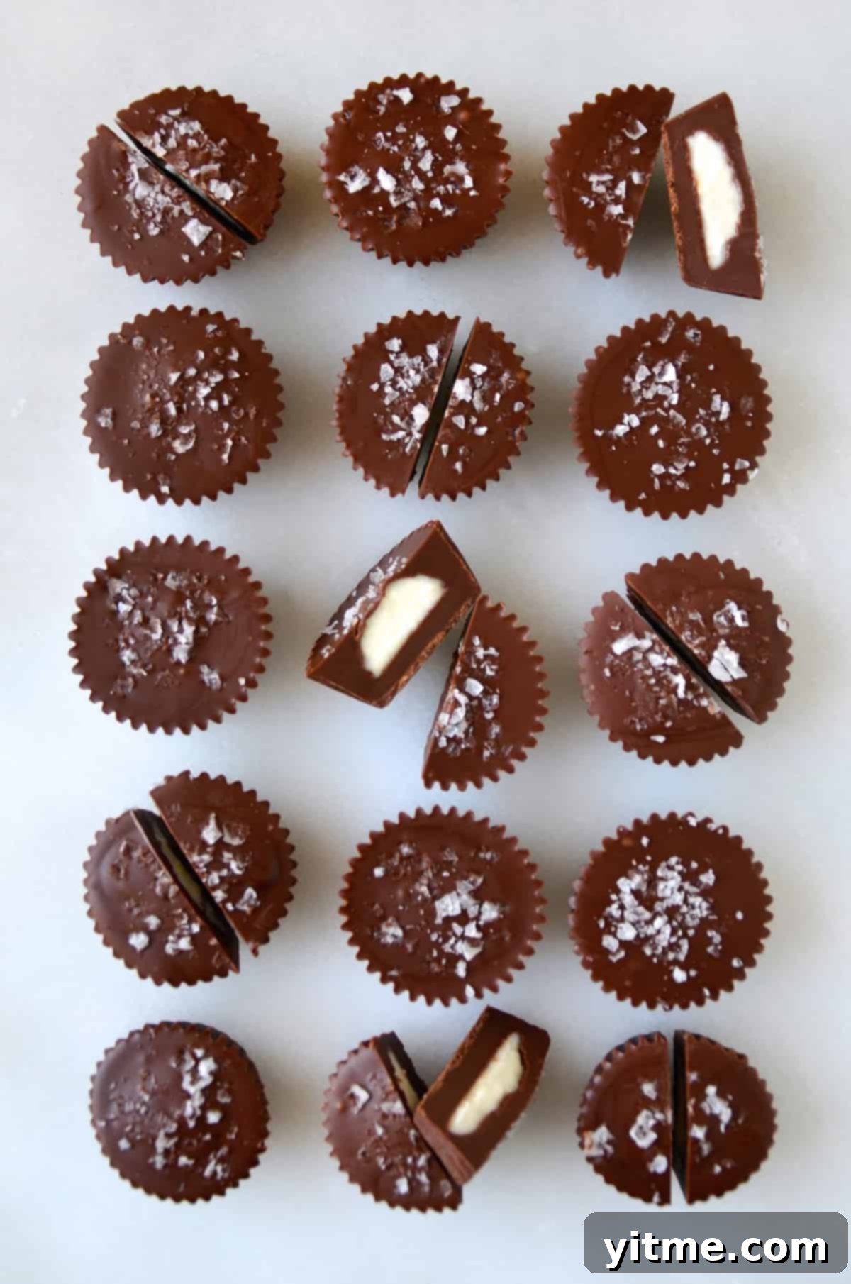 Three rows of chocolate cheesecake cups topped with large-flake sea salt.