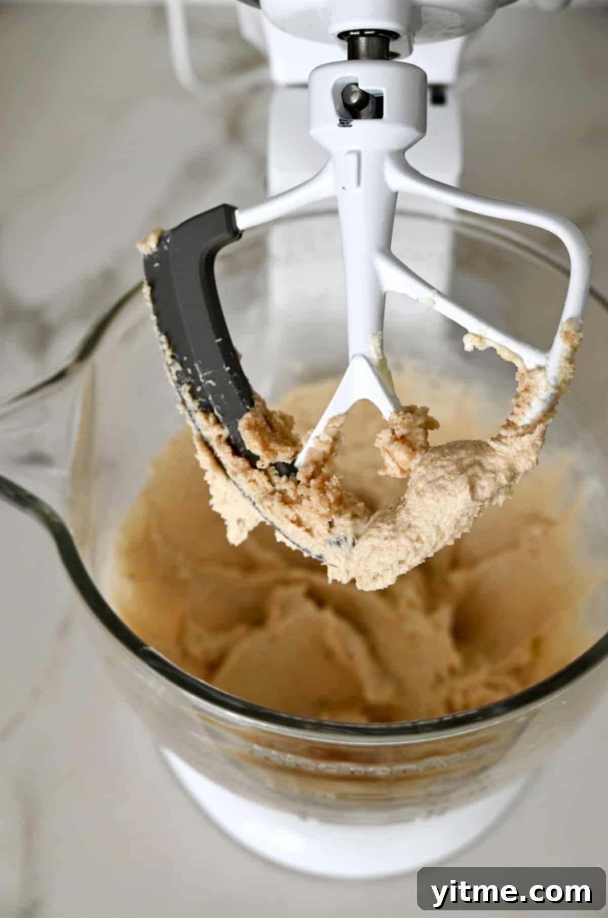 Creaming butter, white sugar, and brown sugar in a stand mixer.