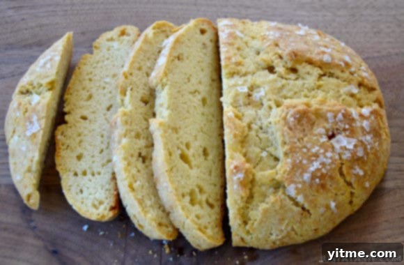 No-Fuss Yeast-Free Breads: Quick & Simple Recipes 3 A loaf of homemade bread cut into slices on a wood cutting board, showcasing the texture of no-yeast bread