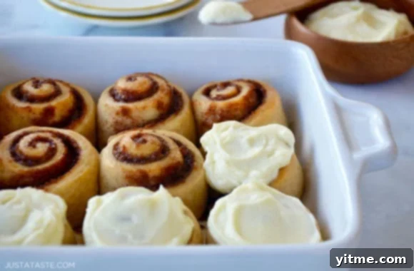 No-Fuss Yeast-Free Breads: Quick & Simple Recipes 6 No-yeast cinnamon rolls in a baking dish with half of them frosted, perfect for a quick and easy dessert
