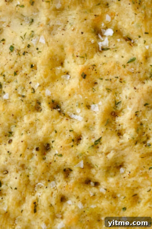 Closeup view of dimpled homemade focaccia bread without yeast