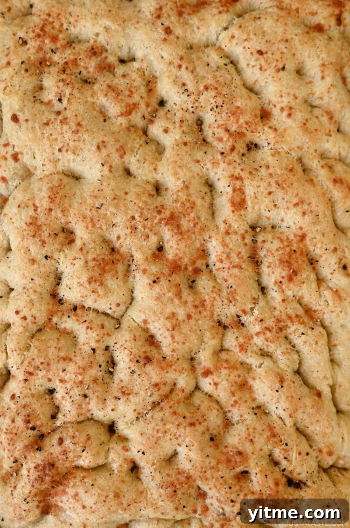 Homemade focaccia with black pepper and grated cheese.