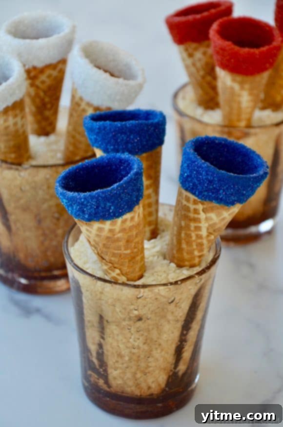 Red, white and blue ice cream cones drying in cups filled with rice