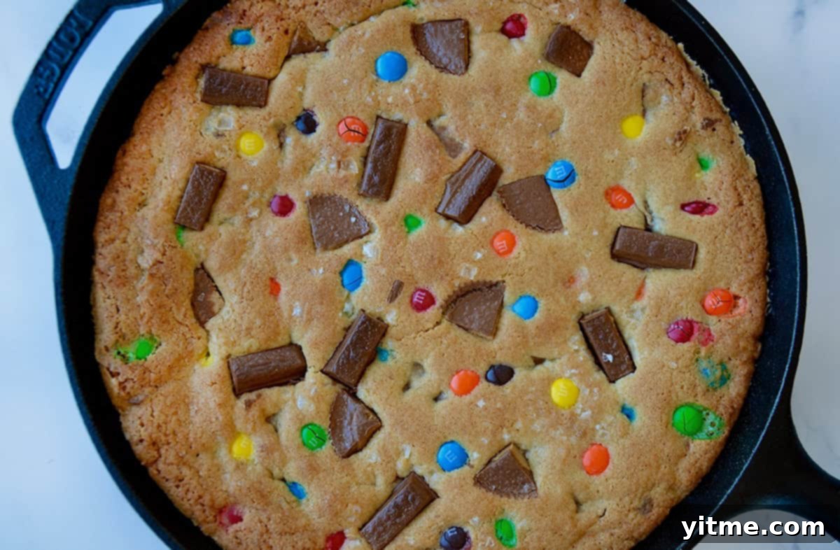 Freshly baked skillet cookie studded with chopped Reese's Peanut Butter Cups, Kit-Kat bars and M&Ms.