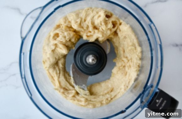 A food processor containing blended banana nice cream