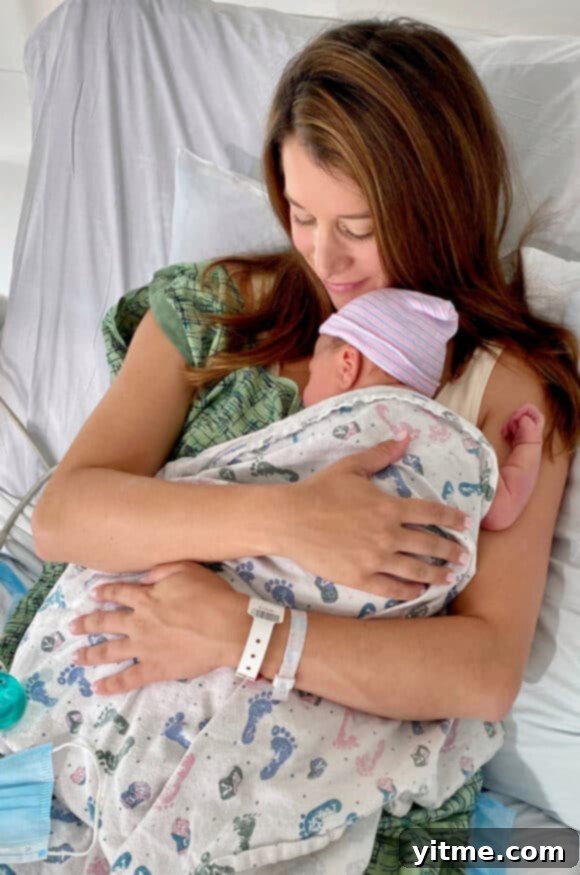 Kelly Senyei, the founder of Just a Taste, sharing a tender moment with her newborn baby son, Dean, reflecting a personal highlight of 2020.