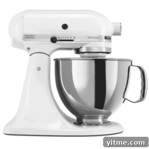 Flavorcast 3 A vibrant red KitchenAid Stand Mixer with its polished stainless steel bowl, an indispensable appliance for any kitchen, representing durability and high performance in baking.