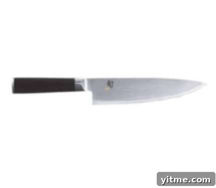 Flavorcast 7 A pristine Shun 8-Inch Chef’s Knife, highlighting its meticulously crafted, razor-sharp blade and ergonomic handle, a professional-grade tool designed for precision and efficiency in all kitchen cutting tasks.