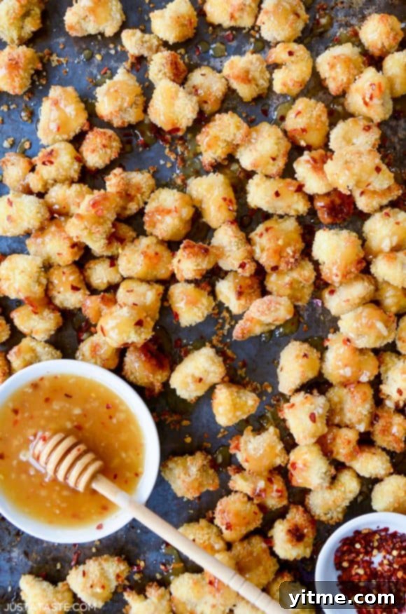 Delicious Baked Popcorn Chicken with Honey-Garlic Glaze topped with crushed red pepper flakes