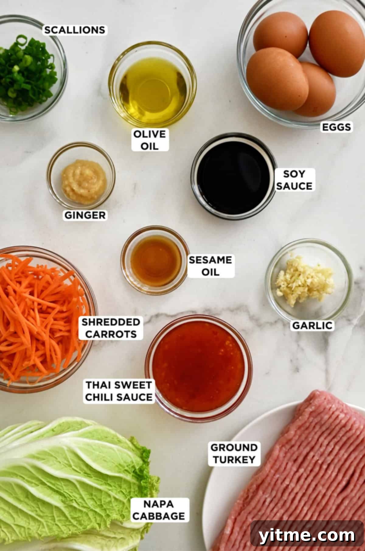 Egg roll bowl ingredients in various sizes of glass bowls.