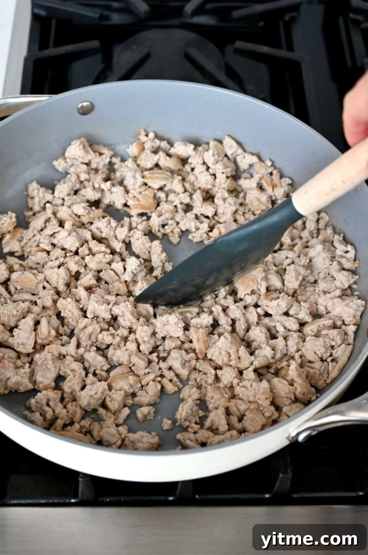 Browning ground turkey in a large skillet.