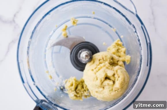 Top down view of food processor with dough