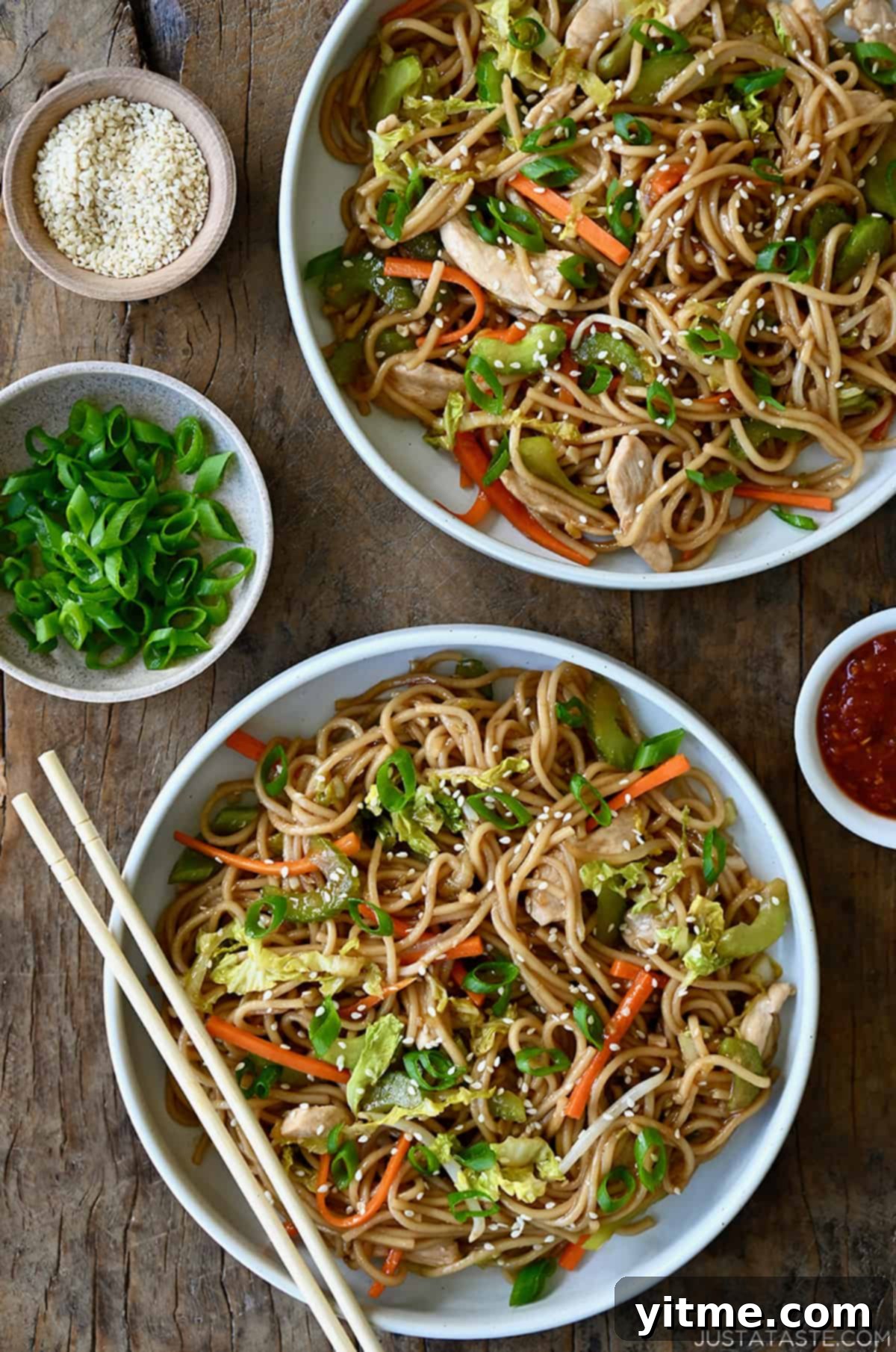 A top-down view of two bowls containing Quick Chicken Chow Mein and chopsticks.