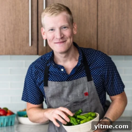 Justin Chapple holding a bowl of shishito peppers