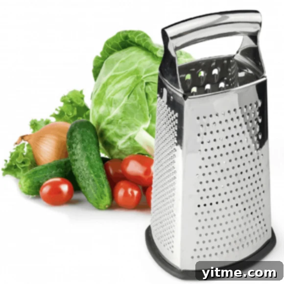 A box grater surrounded by vegetables