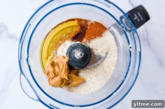 Peanut Butter Bliss Bites 3 Oat flour, peanut butter, honey, and ground cinnamon being processed in a food processor