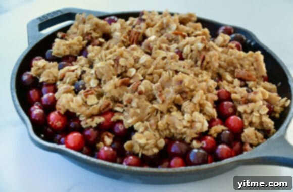 A skillet containing cranberries with crisp topping