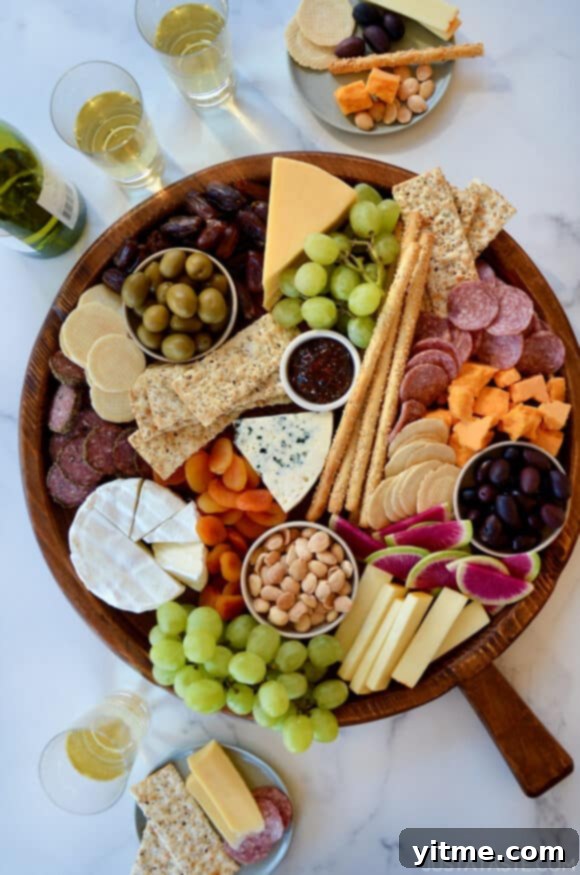 A top down view of a charcuterie board filled with meat, cheese, fruit and crackers. Delicious assortment of charcuterie board ideas.