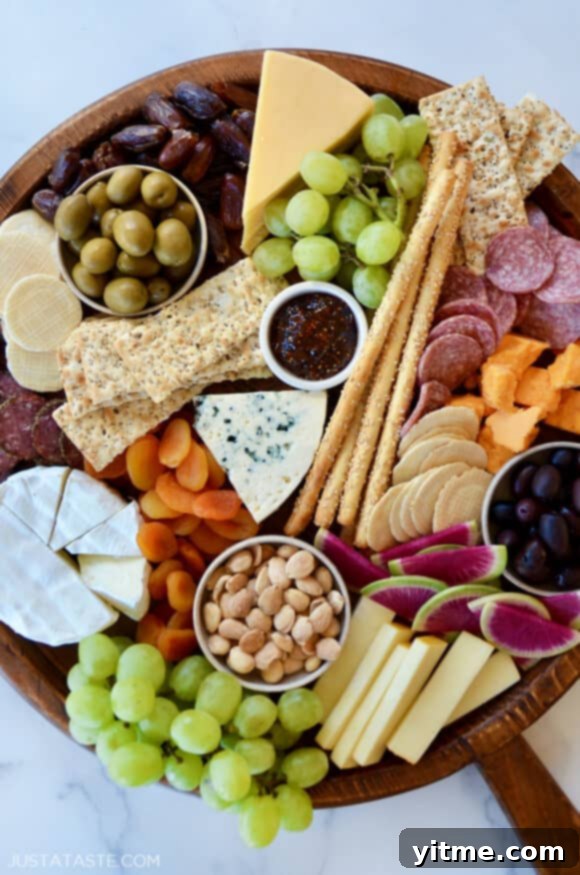 A top down view of the best charcuterie board with cheese, meat and fruit. The perfect arrangement of cheese, meat and fruit for a stunning presentation.