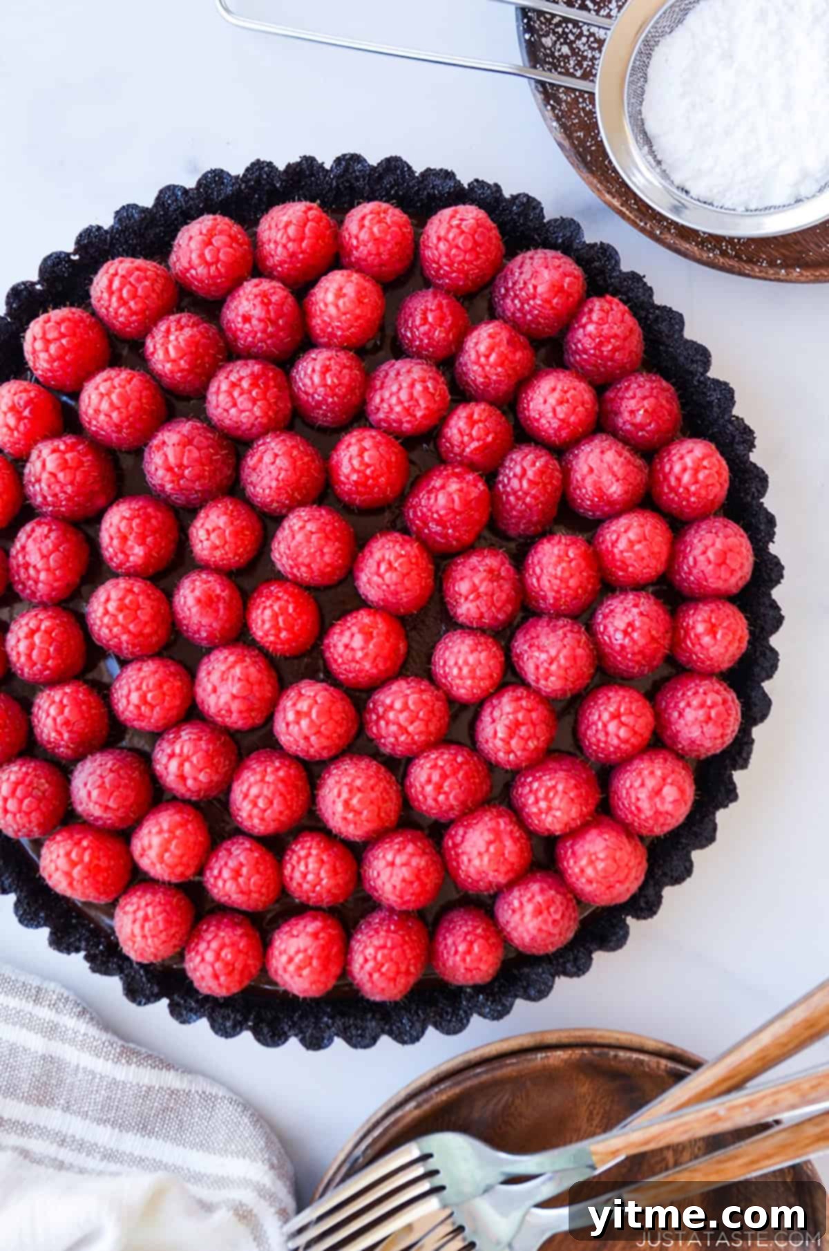 Effortless Raspberry Chocolate Tart 3 A beautiful whole chocolate tart topped with a generous layer of fresh raspberries.