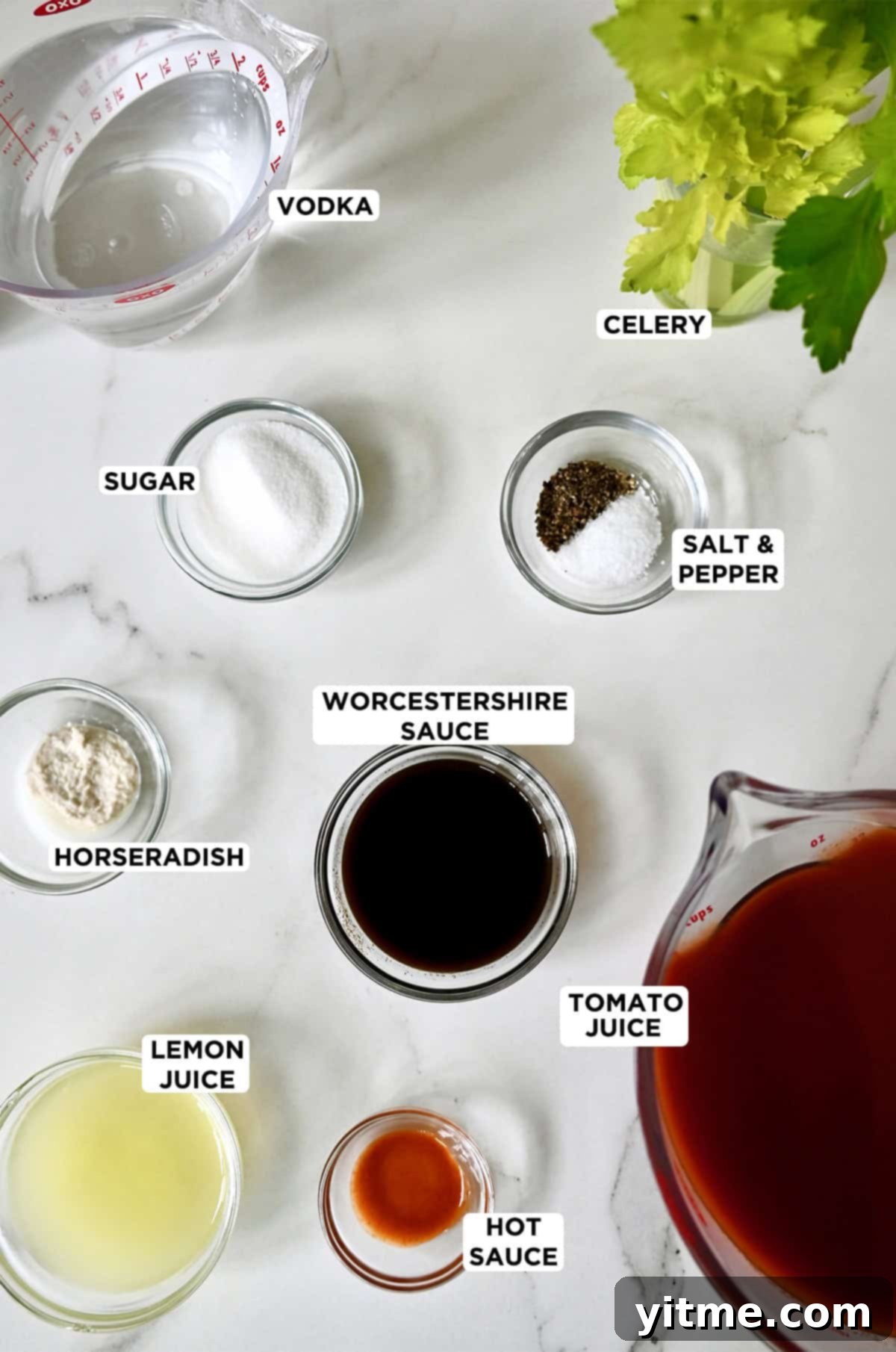 Bloody Mary Pitchers 3 Ingredients to make a Bloody Mary in various sizes of glass bowls, including tomato juice, hot sauce, lemon juice, horseradish, sugar, vodka, Worcestershire sauce, celery stalks, and salt and pepper.