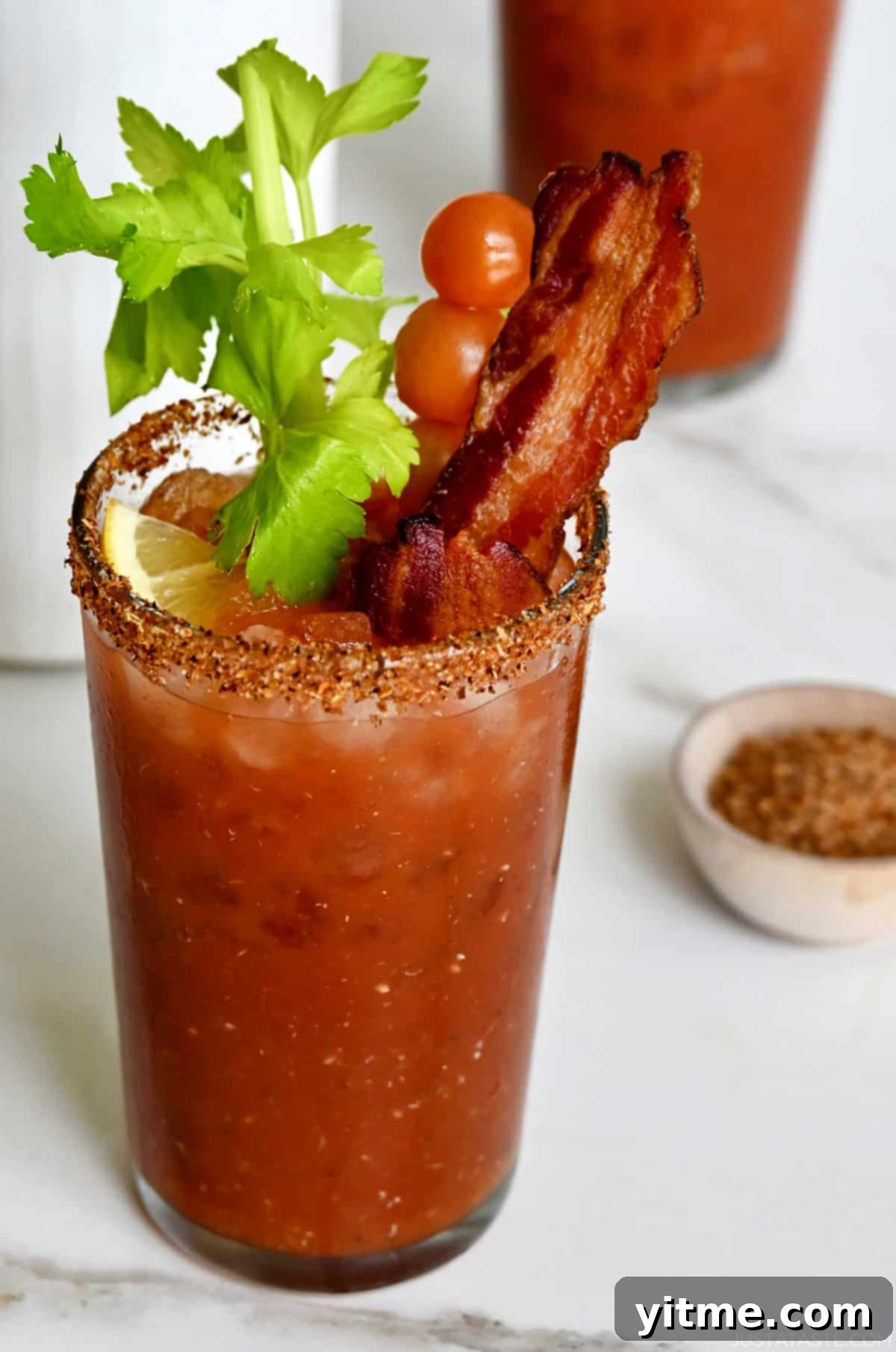 Bloody Mary Pitchers 7 Spicy Bloody Mary garnished with a celery stick, cherry tomatoes on a skewer and crispy bacon.