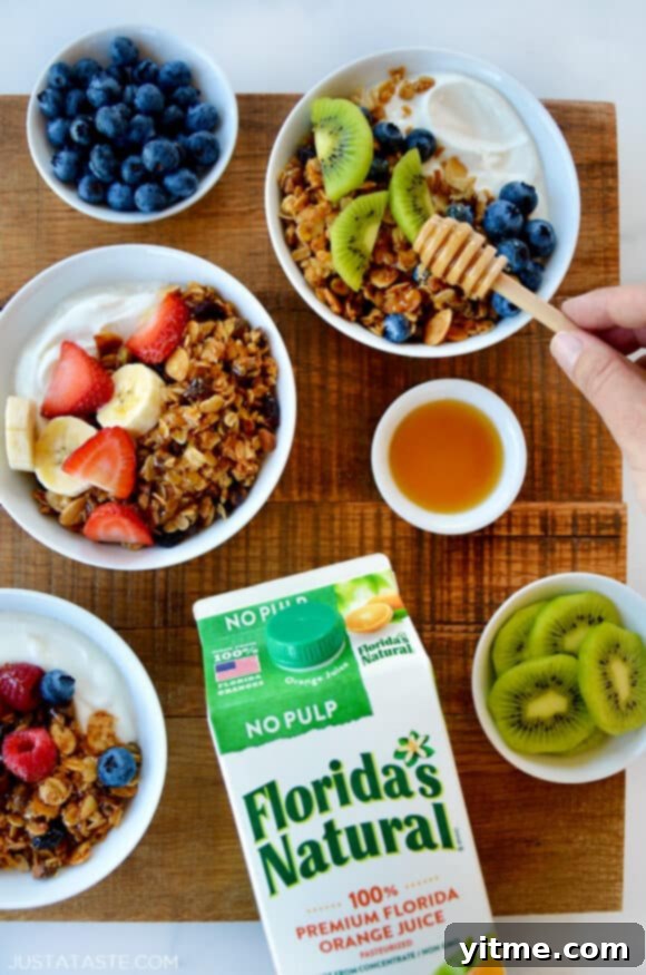 Orange-Kissed Honey Granola Parfaits 7 A top-down view of granola parfaits with fruit and yogurt