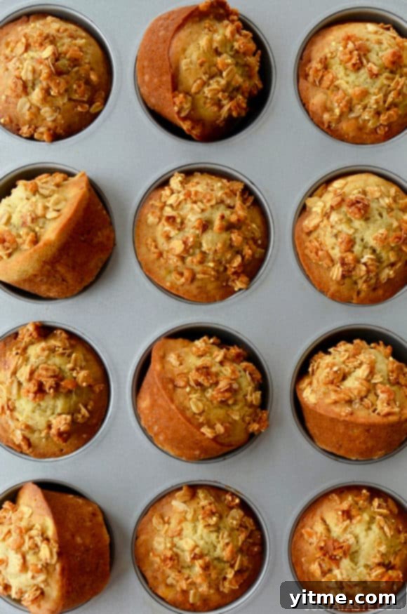 Muffin pan containing freshly baked Banana Granola Muffins