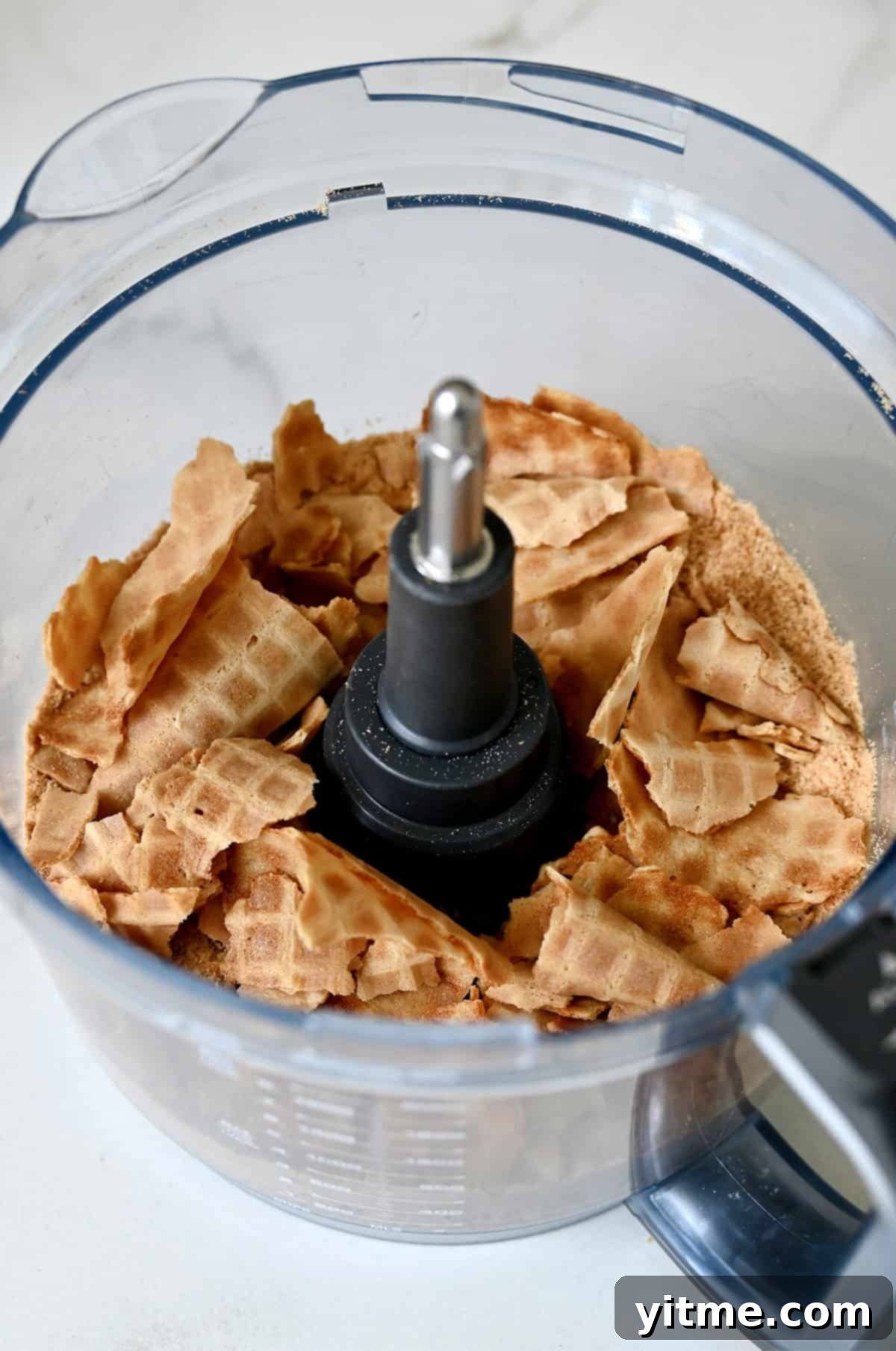 Mystery Ingredient Ice Cream Pie 5 Waffle cones in the bowl of a food processor, ready to be crushed for the pie crust.